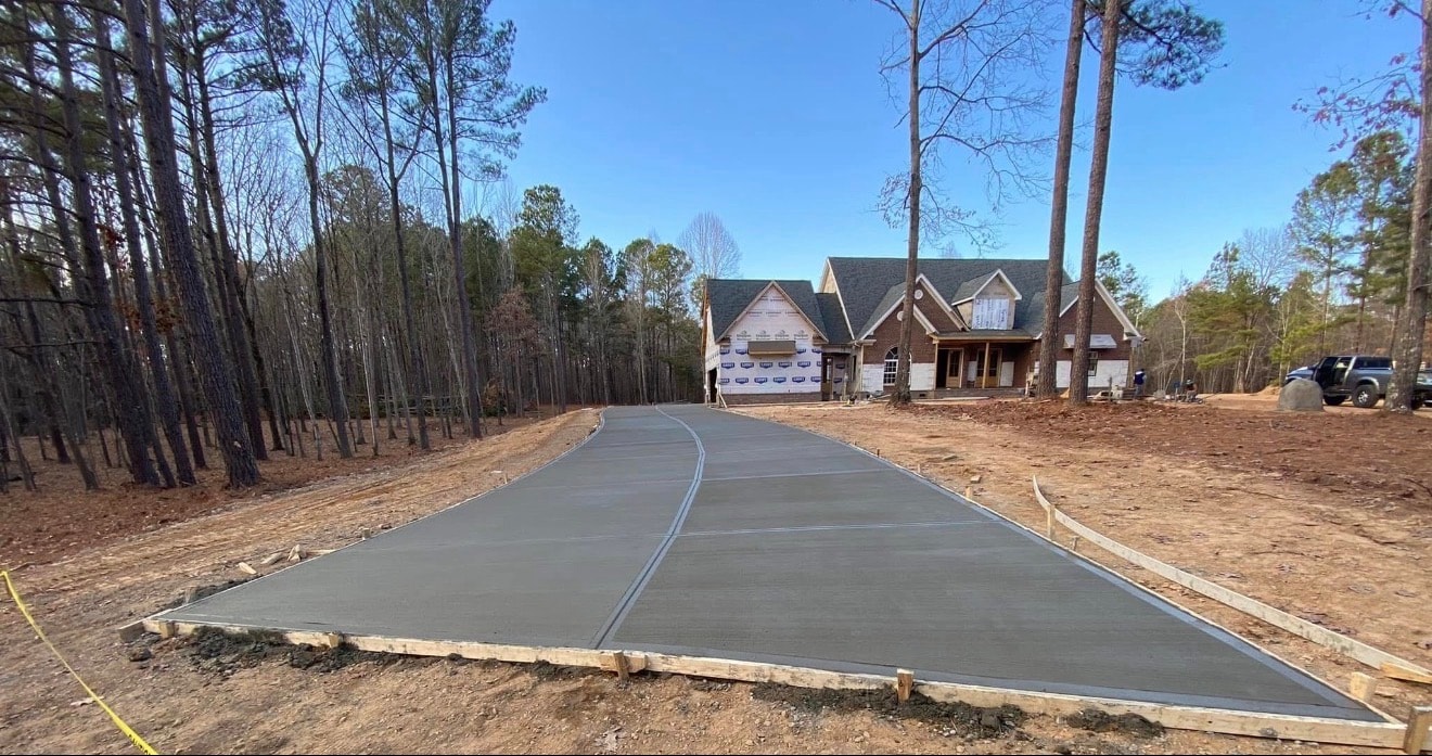 Concrete driveway wooded lot